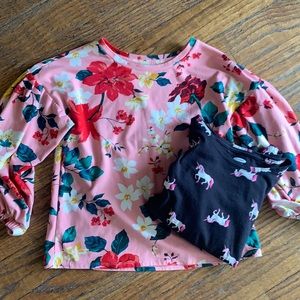 Two shirts. Pink floral and black with unicorns.